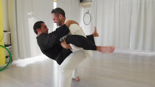 Two Athletes Compete In Karate Moves In The Gym