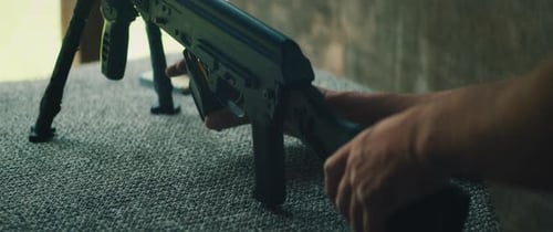 Man Loading Magazine into Rifle at Shooting Range