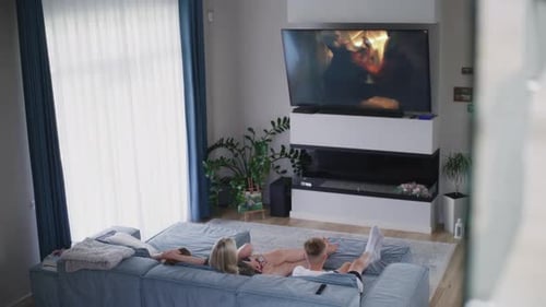 Couple Relaxing At Home Watching Action Movie