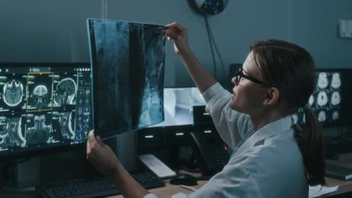 Doctor Examines X-Ray Images in Medical Office