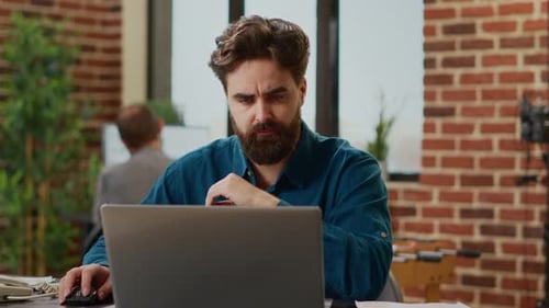 Stressed Exhausted Man Working Under Stress at Office Job