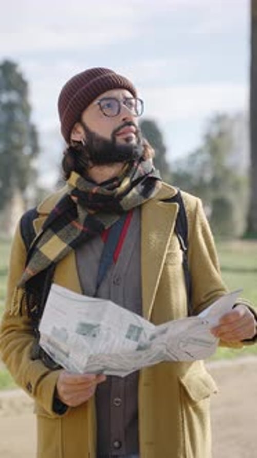 Man Reads Map While Traveling Outdoors