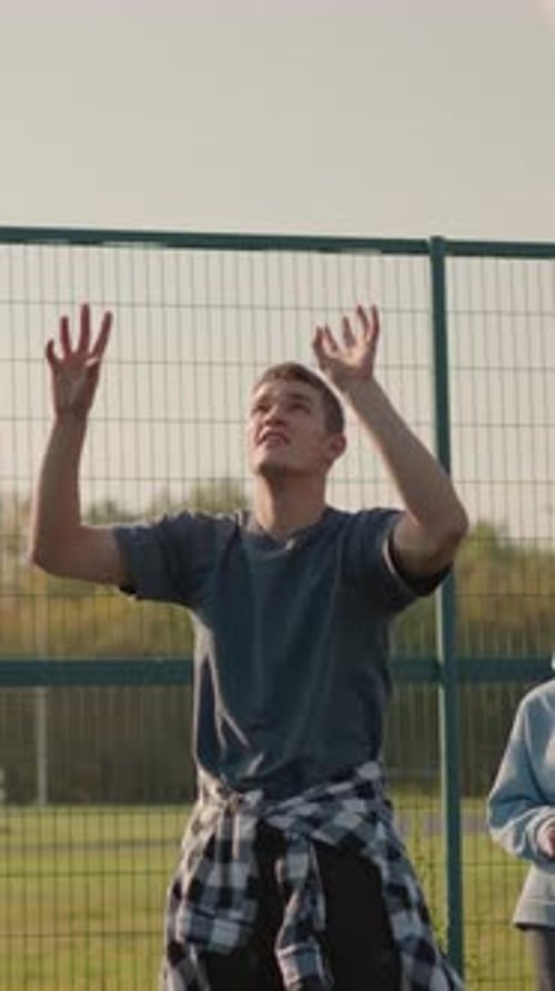 Man Serving Volleyball on an Outdoor Court
