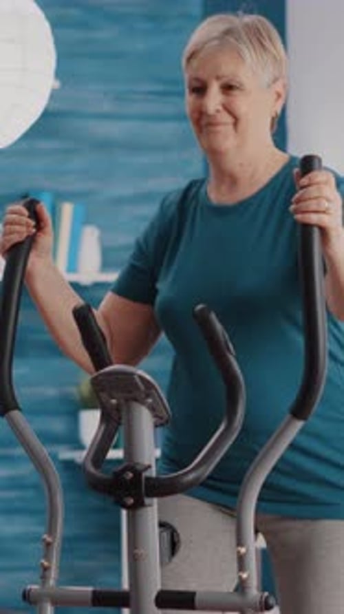 Senior Woman Exercising on Elliptical Machine