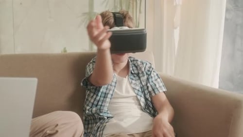 Boy Immersed in Virtual Reality Experience at Home