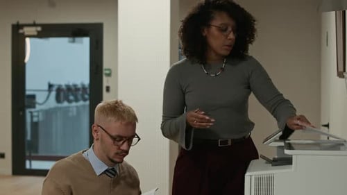 Multiethnic Office Workers Copying Documents on Scanner at Workplace