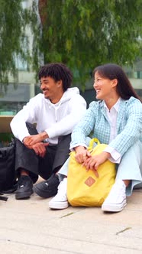 Multiracial Students Sitting and Chatting Relaxed in the University Campus