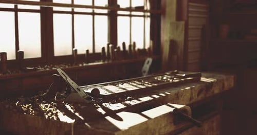 Woodworking Tools on a Workbench in a Rustic Workshop During Daylight Hours