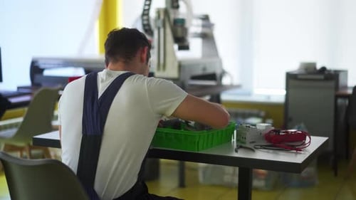 Electrician Assembles Electrical Panel Fuse Box in Workshop Worker Installs Energy Meter Switches