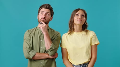 Smiling Couple Thinking and Looking Upward