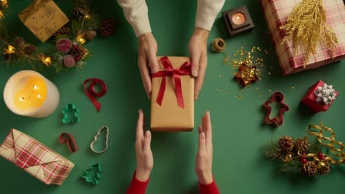 Hands Receiving Christmas Gift Overhead Festive Flat Lay