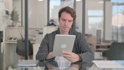Middle Aged Man Working on Digital Tablet
