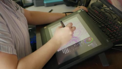Digital Artist Drawing on Tablet at Desk