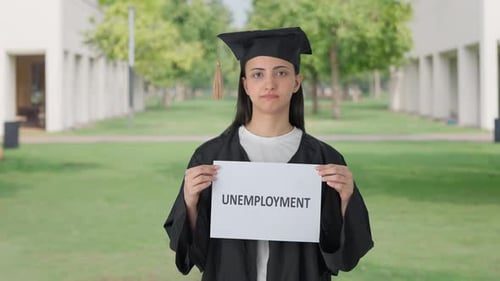Sad Indian college graduate girl holding UNEMPLOYMENT banner