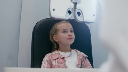 Child Getting Vision Examined with Professional Equipment in Clinic