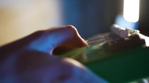 Musician's Hands Delicately Plucking Green Kalimba Traditional African Thumb Piano Metal Tines