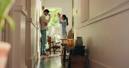 Man and Woman Arguing in a House Hallway