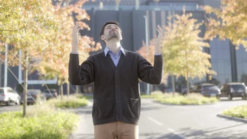 Sad and Tired Businessman Standing Outside Office in Autumn Setting