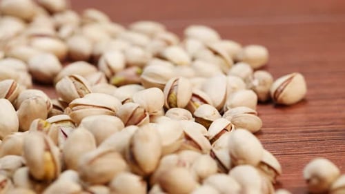 A pile of pistachios on a table