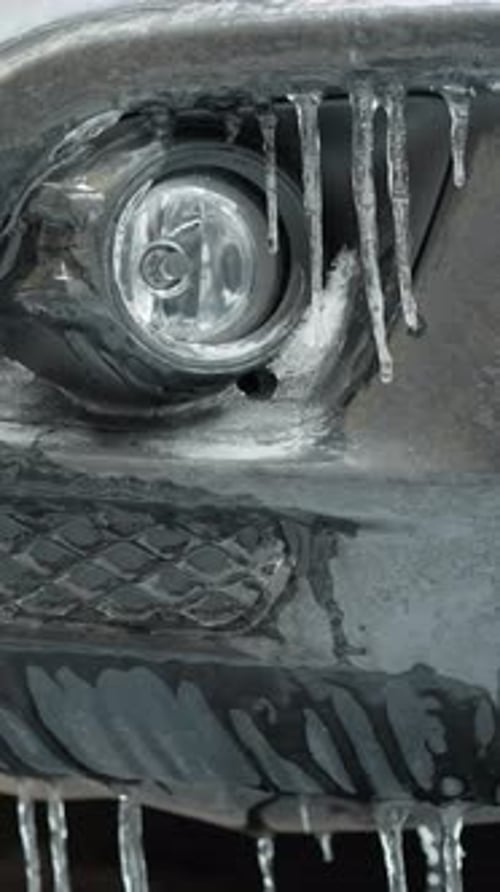 Icy Car Light With Icicles in Cold Winter