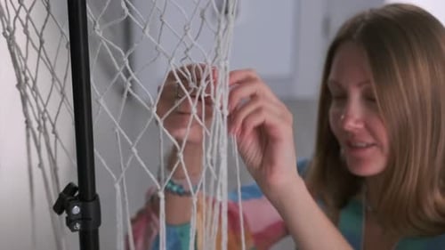 Woman Crafting Macrame Knotting Strings in Home Studio