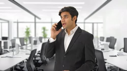 Man in Suit Talking on Phone in Office