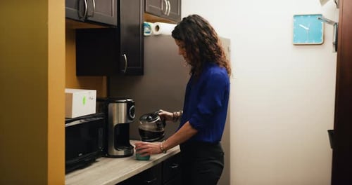 Brunette Office Worker Pours Coffee and Drinks It in Office Kitchen. Medium