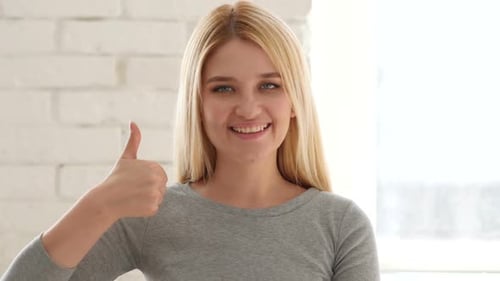 Young Woman Giving Thumbs Up of Approval