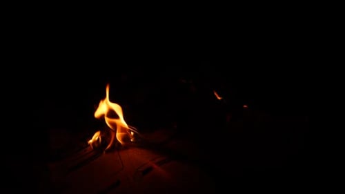 Fire burning illuminating it's sides dark background