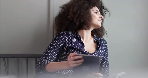 Relaxed Woman Using Tablet at Home
