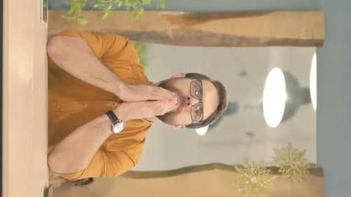 Vertical Video of Pensive Young Businessman Thinking while Sitting in Office