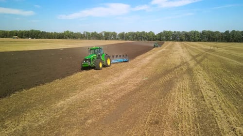 Tractors plowing the field in Ukraine