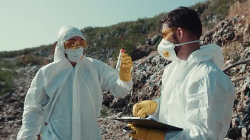 Scientists in Hazmat Suits at a Landfill Analyze Debris
