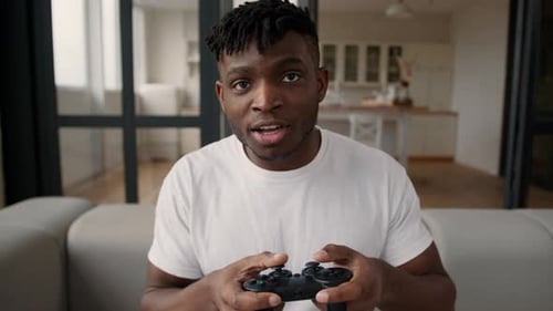 Young Man Playing Video Game on Couch