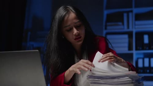 Businesswoman is seriously stressed working overtime bored and burnout due to office syndrome