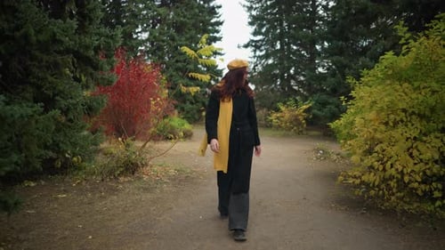 Tourist in Vibrant Garden Smiling in Yellow Beret and Scarf