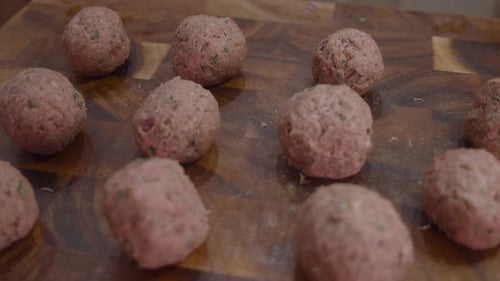 Fresh meat balls on wooden cut board. Close up shot.