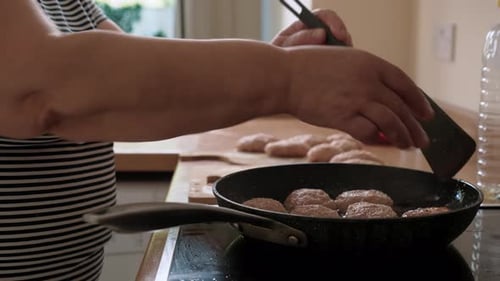 Cutlets Cooking in Pan on Stove Top