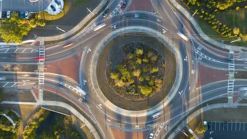 Aerial View of Road Roundabout Intersection with Fast Moving Heavy Traffic Timelapse of Urban
