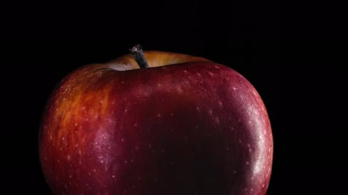 Rotating Close-up of a Juicy Red Apple with Droplets - 4K
