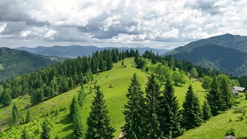 Sunny Mountain Landscape With Dense Forest Aerial View of Green Hills and Dramatic Clouds Over