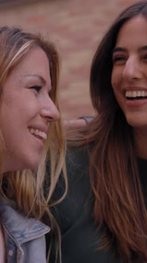 Diverse Group of Joyful Generation z Friends Having Fun Standing Embracing on City Street Together
