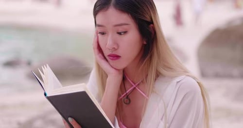 Summer Vacation Asian Woman Reading a Book on the Beach in Free Time Holiday
