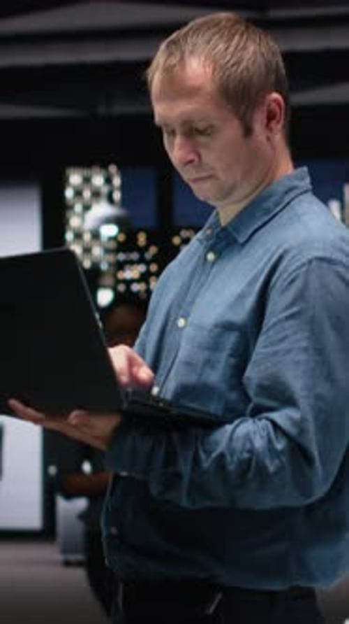 Vertical Video Software Developer in Office Using Laptop to Fix Artificial Intelligence Bugs