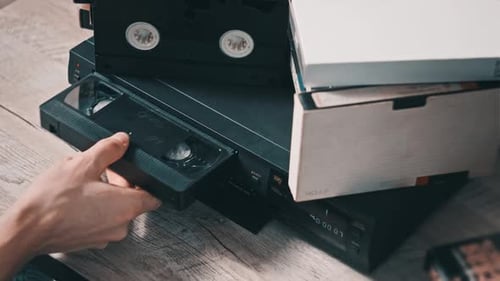Insert VHS Cassette Into VCR Video Player