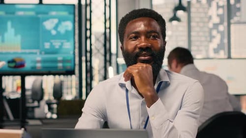 Portrait of African American Businessman Analyzing KPI Metrics and Insights
