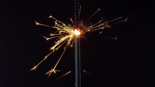 Sparkling Sparkler Emitting Bright Yellow and Orange Sparks