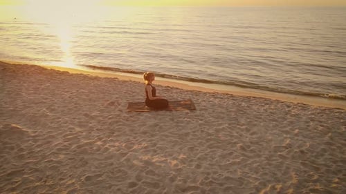 Focused Woman Practicing Meditation Raising Hands Up on Sandy Beach Summer Evening Yoga Woman
