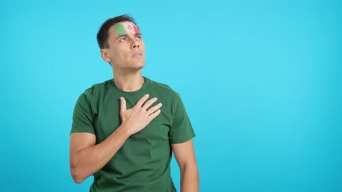 Man Listening to the Mexico National Anthem with Solemnity