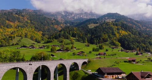 Aerial View of the Beautiful Swiss Nature with Railroad Bridge and Village